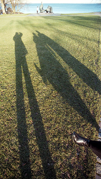 Long shadows with foot, outside the Louisiana Art Gallery, Northern Sealand, Denmark.